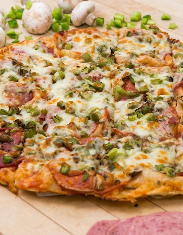 Fresh thin-crust pizza for community fundraisers in Steinbach, MB.]